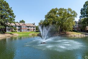 Germantown apartment for rent - a fountain in the middle of a lake with an apartment building in the background at The Grove Germantown Apartments, Tennessee ?