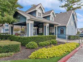Houston apartment for rent - A blue house with a porch and a sign on the front.