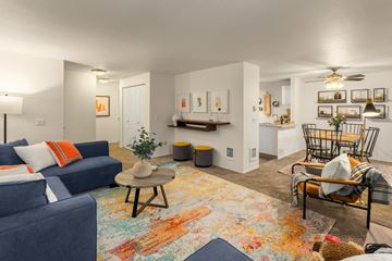 Kent apartment for rent - A living room with a blue couch and a rug with a bear on it.