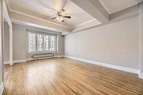 Denver apartment for rent - A room with wooden floors and a ceiling fan.