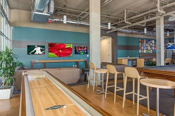 Game room with shuffleboard, poker table, pool table, foosball table, air hockey table & darts