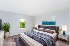 Lewis Center townhouse for rent - A bedroom with a large bed and a window.
