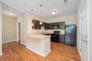 Westerville apartment for rent - a kitchen with a large island and a black refrigerator