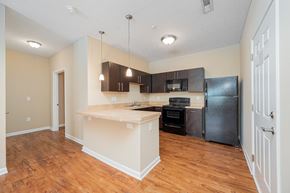 Westerville apartment for rent - a kitchen with a large island and a black refrigerator