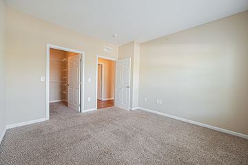 Westerville apartment for rent - a spacious living room with carpet and a closet