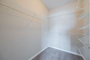 Westerville apartment for rent - a spacious walk in closet in an empty room with empty shelves