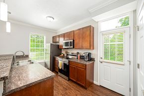 Powell townhouse for rent - a kitchen with stainless steel appliances and wooden cabinets