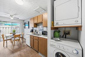 Columbus townhouse for rent - A small kitchen with a washing machine on top of the counter.