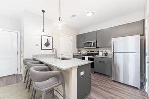 Columbus apartment for rent - A kitchen with a white counter top and grey chairs.