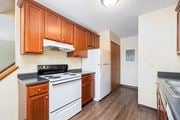 Dublin apartment for rent - a kitchen with white appliances and wooden cabinets