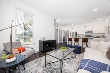 Columbus apartment for rent - A modern living room with a glass coffee table and a grey sofa.