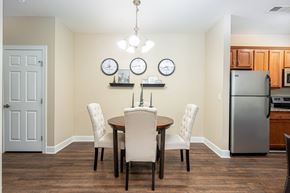 Westerville townhouse for rent - a dining room with a table and chairs and a refrigerator