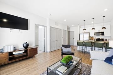 Marysville apartment for rent - A modern living room with a black coffee table and a flat screen TV mounted on the wall.