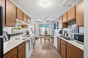 Columbus townhouse for rent - A kitchen with wooden cabinets and a white countertop.