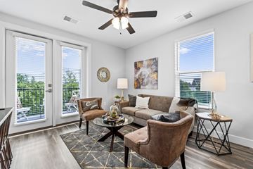 Columbus apartment for rent - A living room with a brown chair and a brown couch.
