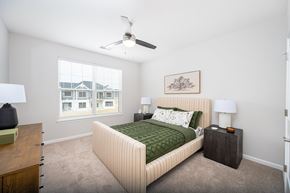 Sunbury apartment for rent - A bedroom with a large bed and a ceiling fan.
