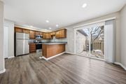 Dublin townhouse for rent - A kitchen with wooden cabinets and a refrigerator.