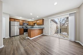 Dublin townhouse for rent - A kitchen with wooden cabinets and a refrigerator.