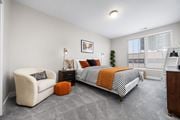 Columbus townhouse for rent - A bedroom with a bed, chair, and nightstand.