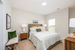 Marysville apartment for rent - A bedroom with a large bed and a chair.