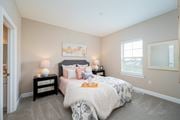 Grove City townhouse for rent - a bedroom with a bed and a window