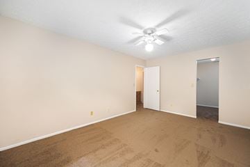 Galloway apartment for rent - a spacious living room with carpet and a ceiling fan
