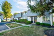 Circleville apartment for rent - a sidewalk in front of a building with trees