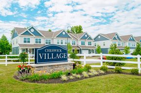Powell townhouse for rent - the village apartments sign in front of fence and building