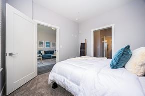 Columbus apartment for rent - a bedroom with a white bed and a closet