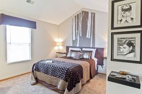 Westerville apartment for rent - a bedroom with a bed and pictures on the wall