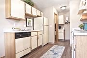 Hilliard townhouse for rent - a spacious kitchen with white appliances and wooden cabinets