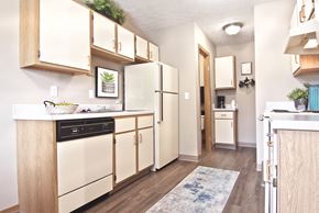 Hilliard townhouse for rent - a spacious kitchen with white appliances and wooden cabinets