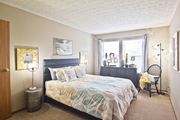 Hilliard townhouse for rent - a bedroom with a bed and a dresser and a window