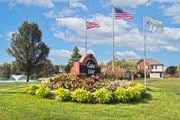 Hilliard townhouse for rent - the civic center sign with flags and flowers in the grass