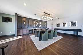 Marysville apartment for rent - A modern dining room with a dark wood table and green chairs.