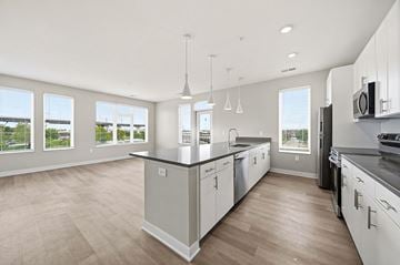 Columbus apartment for rent - A modern kitchen with white cabinets and a large island.