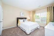 Columbus apartment for rent - a bedroom with a bed and a large window