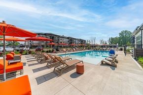 Westerville apartment for rent - A pool area with sun loungers and umbrellas.
