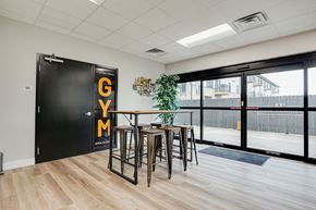 Columbus apartment for rent - a dining area with bar stools and a table in front of a large window