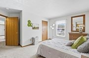 Marysville apartment for rent - A bedroom with a large bed and a mirror on the dresser.