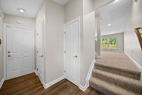 Westerville townhouse for rent - A hallway with a staircase leading to a balcony.