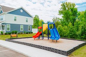 Powell townhouse for rent - a playground with two slides in front of a house