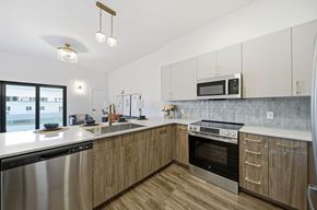 Dayton apartment for rent - A modern kitchen with wooden cabinets and stainless steel appliances.