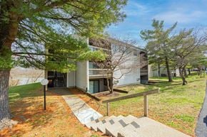 Newark apartment for rent - A house with a white exterior and a tree in front of it.