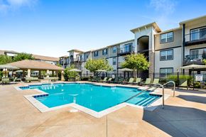 Hilliard apartment for rent - A large swimming pool in front of apartment buildings.