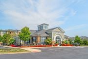 Westerville apartment for rent - an exterior view of a building with a parking lot