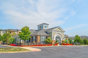 Westerville apartment for rent - an exterior view of a building with a parking lot