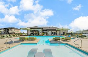 Marysville apartment for rent - A large outdoor swimming pool with sun loungers and a building in the background.