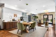 Columbus townhouse for rent - A modern dining room with a wooden table and green chairs.
