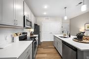 Columbus townhouse for rent - A modern kitchen with white cabinets and stainless steel appliances.